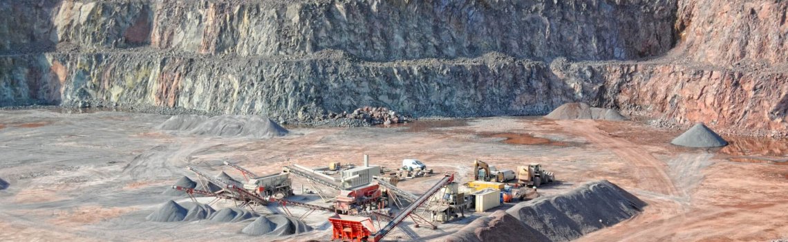 stone crusher in a quarry. mining industry. repairing service on excavator.